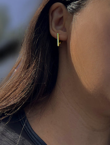 Image Title Female model wearing ACHIEVE TRIANGLE GEOMETRIC HUGGIE EARRINGS IN 18K GOLD VERMEIL With Sterling Silver base by Sonia Hou Jewelry