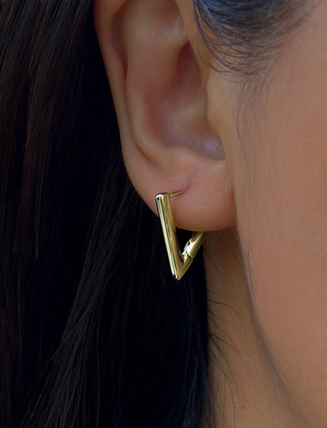 Image Title Female model wearing ACHIEVE TRIANGLE GEOMETRIC HUGGIE EARRINGS in Sterling Silver by Sonia Hou Jewelry