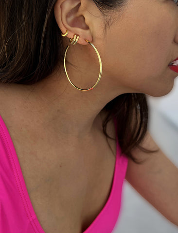 Image Title Woman wearing Essential Minimalist 18K Gold Vermeil With 925 Sterling Silver base mini small tiny chunky bold thick dainty stacking layering statement round hoop huggie ear stack earrings by Sonia Hou, a celebrity AAPI Chinese demi-fine jewelry designer