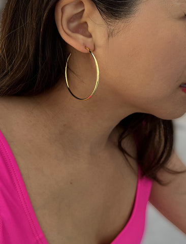 Image Title Female model wearing big medium large thin round circle PERFECT 50mm 2 inch hoop stacking lightweight everyday statement earrings in 18K Gold Vermeil With 925 Sterling Silver base by Sonia Hou, a celebrity AAPI Chinese demi-fine jewelry designer