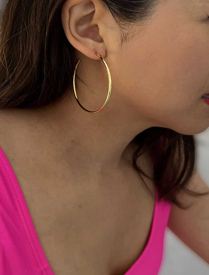 Image Title Female model wearing big medium large thin round circle PERFECT 50mm 2 inch hoop stacking lightweight everyday statement earrings in 18K Gold Vermeil With 925 Sterling Silver base by Sonia Hou, a celebrity AAPI Chinese demi-fine jewelry designer