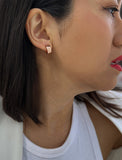 Female model wearing BOSS 18K ROSE GOLD VERMEIL OVER STERLING SILVER MINIMALIST CHUBBY MINI SMALL HOOP EARRINGS by Sonia Hou Jewelry