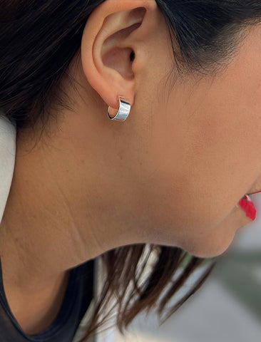 Image Title Female model wearing minimalist dainty small thick bold everyday BOSS 925 Sterling Silver Chubby Mini Huggie Hoop Earrings by Sonia Hou, a celebrity Chinese AAPI demi-fine fashion costume jewelry designer