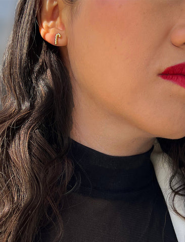 Image Title Female model wearing Candy Cane Holiday Festive Christmas Earrings in 18K Gold Over With Sterling Silver by AAPI Celebrity Jewelry Designer Sonia Hou