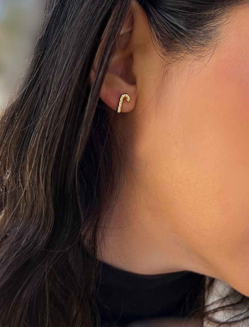 Image Title Female model wearing Candy Cane Holiday Festive Christmas Earrings in 18K Gold Over With Sterling Silver by AAPI Celebrity Jewelry Designer Sonia Hou