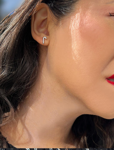 Image Title Female model wearing Candy Cane Holiday Festive Christmas Earrings in Sterling Silver by AAPI Celebrity Jewelry Designer Sonia Hou