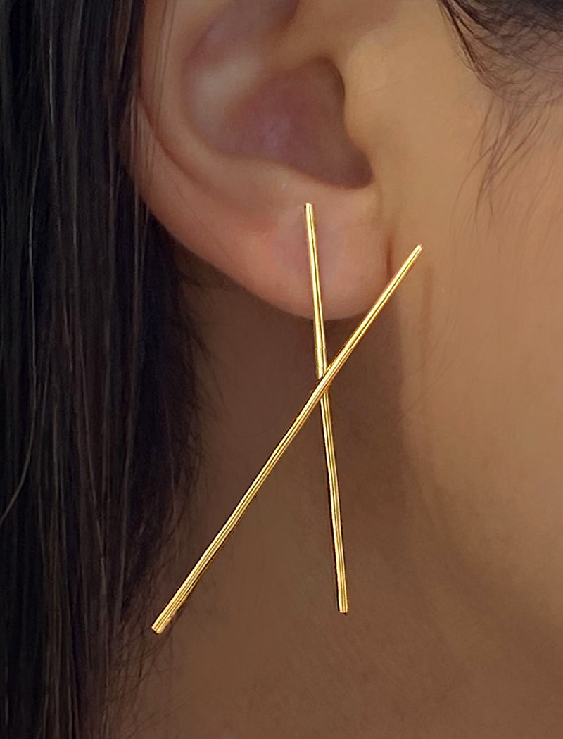 Image Title Female Model wearing Asian Inspired Chopsticks Minimalist Long Thin Dangle Earrings in 18K Gold Vermeil With Sterling Silver base by Sonia Hou, a celebrity AAPI demi-fine jewelry designer.