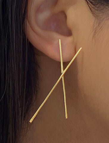 Image Title Female Model wearing Asian Inspired Chopsticks Minimalist Long Thin Dangle Earrings in 18K Gold Vermeil With Sterling Silver base by Sonia Hou, a celebrity AAPI demi-fine jewelry designer.