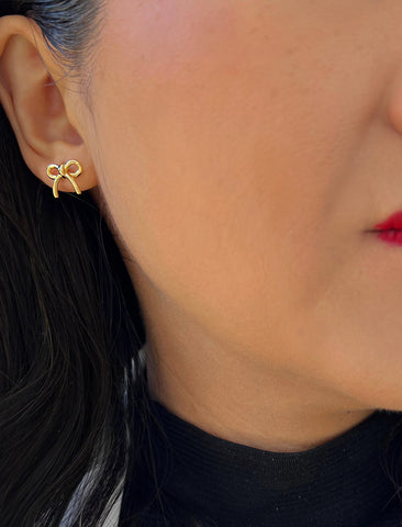 Image Title Female model wearing Holiday Coquette Bow Festive Christmas Stud Earrings in 18K Gold Over With Sterling Silver by AAPI Celebrity Jewelry Designer Sonia Hou