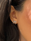Image Title Female model wearing Holiday Coquette Bow Festive Christmas Stud Earrings in Sterling Silver by AAPI Celebrity Jewelry Designer Sonia Hou