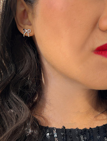 Image Title Female model wearing Holiday Coquette Bow Festive Christmas Stud Earrings in Sterling Silver by AAPI Celebrity Jewelry Designer Sonia Hou
