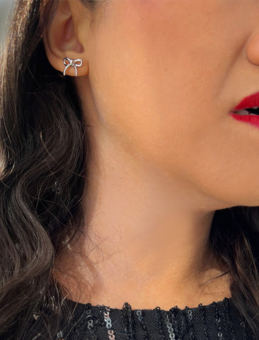 Image Title Female model wearing Holiday Coquette Bow Festive Christmas Stud Earrings in Sterling Silver by AAPI Celebrity Jewelry Designer Sonia Hou