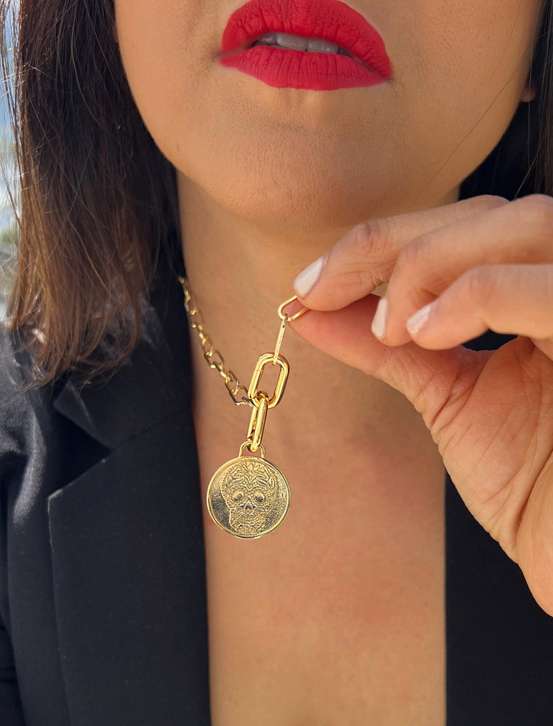 Image Title Female model wearing gender neutral, culturally inclusive Day Of The Dead Mexican Sugar Skull Charm 3-Way Convertible Coin Pendant with a Large Paperclip Link Chain Statement Bold Thick Chunky Layering Stacking Rectangular Necklace in 18K Gold Vermeil Over Sterling Silver by Sonia Hou, a celebrity AAPI Chinese demi-fine jewelry designer. This holiday is also known as Dia De Los Muertos, and can also be worn for Halloween!