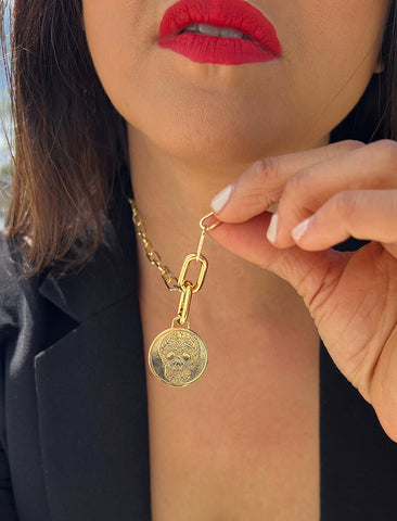Image Title Female model wearing gender neutral, culturally inclusive Day Of The Dead Mexican Sugar Skull Charm 3-Way Convertible Coin Pendant with a Large Paperclip Link Chain Statement Bold Thick Chunky Layering Stacking Rectangular Necklace in 18K Gold Vermeil Over Sterling Silver by Sonia Hou, a celebrity AAPI Chinese demi-fine jewelry designer. This holiday is also known as Dia De Los Muertos, and can also be worn for Halloween!