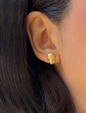 Image Title Woman wearing Culturally inclusive Day Of The Dead Mexican Sugar Skull Stud Earrings in 18K Gold over Sterling Silver by Sonia Hou, a celebrity AAPI Chinese demi-fine jewelry designer. This holiday is also known as Dia De Los Muertos, and can also be worn for Halloween!