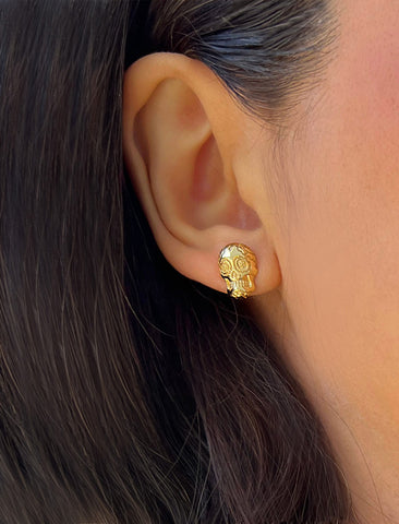Image Title Woman wearing Culturally inclusive Day Of The Dead Mexican Sugar Skull Stud Earrings in 18K Gold over Sterling Silver by Sonia Hou, a celebrity AAPI Chinese demi-fine jewelry designer. This holiday is also known as Dia De Los Muertos, and can also be worn for Halloween!