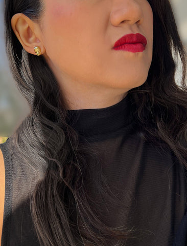 Image Title Woman wearing Culturally inclusive Day Of The Dead Mexican Sugar Skull Stud Earrings in 18K Gold over Sterling Silver by Sonia Hou, a celebrity AAPI Chinese demi-fine jewelry designer. This holiday is also known as Dia De Los Muertos, and can also be worn for Halloween!