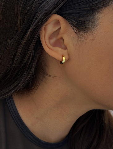 Image Title Woman wearing Essential Minimalist 18K Gold Vermeil With 925 Sterling Silver base mini small tiny chunky bold thick dainty stacking layering statement round hoop huggie earrings by Sonia Hou, a celebrity AAPI Chinese demi-fine jewelry designer