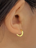 Woman wearing Essential Minimalist 18K Gold Vermeil With 925 Sterling Silver base mini small tiny chunky bold thick dainty stacking layering statement round hoop huggie earrings by Sonia Hou, a celebrity AAPI Chinese demi-fine jewelry designer