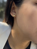 Image Title Female model wearing tiny dainty small minimalist inclusive Evil Eye Stud Earrings, inspired by Greek culture, in 18K Gold Vermeil With Sterling Silver base by Sonia Hou, a celebrity AAPI Chinese demi-fine fashion costume jewelry designer