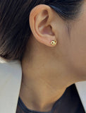 Female model wearing tiny dainty small minimalist inclusive Evil Eye Stud Earrings, inspired by Greek culture, in 18K Gold Vermeil With Sterling Silver base by Sonia Hou, a celebrity AAPI Chinese demi-fine fashion costume jewelry designer