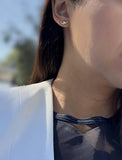 Image Title Female model wearing tiny dainty small minimalist inclusive Evil Eye Stud Earrings, inspired by Greek culture, in 925 Sterling Silver by Sonia Hou, a celebrity Asian AAPI Chinese demi-fine fashion costume jewelry designer