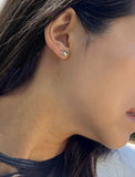 Image Title Female model wearing tiny dainty small minimalist inclusive Evil Eye Stud Earrings, inspired by Greek culture, in 925 Sterling Silver by Sonia Hou, a celebrity Asian AAPI Chinese demi-fine fashion costume jewelry designer