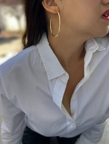 Image Title Female model wearing big medium large thin round circle PERFECT 50mm 2 inch hoop stacking lightweight everyday statement earrings in 18K Gold Vermeil With 925 Sterling Silver base by Sonia Hou, a celebrity AAPI Chinese demi-fine jewelry designer