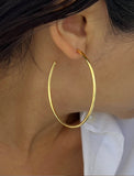 Female model wearing big medium large thin round circle PERFECT 50mm 2 inch hoop stacking lightweight everyday statement earrings in 18K Gold Vermeil With 925 Sterling Silver base by Sonia Hou, a celebrity AAPI Chinese demi-fine jewelry designer