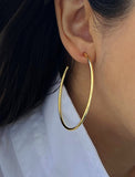 Female model wearing big medium large thin round circle PERFECT 50mm 2 inch hoop stacking lightweight everyday statement earrings in 18K Gold Vermeil With 925 Sterling Silver base by Sonia Hou, a celebrity AAPI Chinese demi-fine jewelry designer