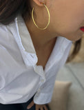 Female model wearing big medium large thin round circle PERFECT 50mm 2 inch hoop stacking lightweight everyday statement earrings in 18K Gold Vermeil With 925 Sterling Silver base by Sonia Hou, a celebrity AAPI Chinese demi-fine jewelry designer