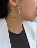 Female model wearing big medium large thin round circle PERFECT 50mm 2 inch hoop stacking lightweight everyday statement earrings in 18K Gold Vermeil With 925 Sterling Silver base by Sonia Hou, a celebrity AAPI Chinese demi-fine jewelry designer