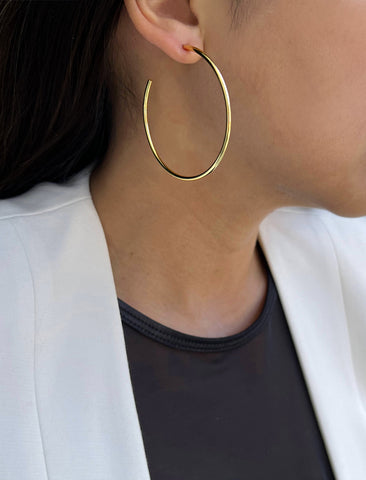 Image Title Female model wearing big medium large thin round circle PERFECT 50mm 2 inch hoop stacking lightweight everyday statement earrings in 18K Gold Vermeil With 925 Sterling Silver base by Sonia Hou, a celebrity AAPI Chinese demi-fine jewelry designer