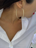 Female model wearing big medium large thin round circle PERFECT 50mm 2 inch hoop stacking lightweight everyday statement earrings in 925 Sterling Silver by Sonia Hou, a celebrity AAPI Chinese demi-fine jewelry designer