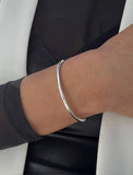 Female model wearing adjustable minimalist simple Success Thin Cuff Chunky Bold Layering Stacking Statement 2 Way convertible Bangle Cuff Open Bracelet in 925 sterling silver by Sonia Hou, a celebrity AAPI Chinese demi-fine fashion costume jewelry designer