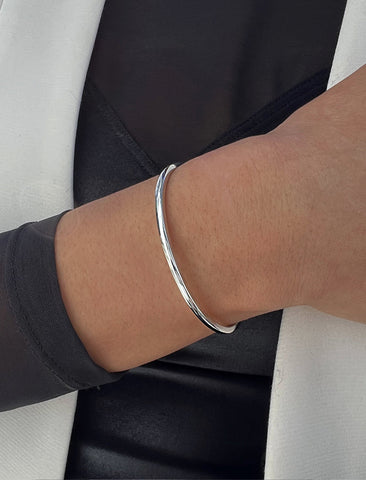 Image Title Female model wearing adjustable minimalist simple Success Thin Cuff Chunky Bold Layering Stacking Statement 2 Way convertible Bangle Cuff Open Bracelet in 925 sterling silver by Sonia Hou, a celebrity AAPI Chinese demi-fine fashion costume jewelry designer