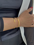 Image Title Female model wearing adjustable minimalist simple Success Thin Cuff Chunky Bold Layering Stacking Statement 2 Way convertible Bangle Cuff Open Bracelet in 18K Gold Vermeil with 925 sterling silver base by Sonia Hou, a celebrity AAPI Chinese demi-fine fashion costume jewelry designer