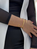 Female model wearing adjustable minimalist simple Success Thin Cuff Chunky Bold Layering Stacking Statement 2 Way convertible Bangle Cuff Open Bracelet in 18K Gold Vermeil with 925 sterling silver base by Sonia Hou, a celebrity AAPI Chinese demi-fine fashion costume jewelry designer