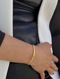 Female model wearing adjustable minimalist simple Success Thin Cuff Chunky Bold Layering Stacking Statement 2 Way convertible Bangle Cuff Open Bracelet in 18K Gold Vermeil with 925 sterling silver base by Sonia Hou, a celebrity AAPI Chinese demi-fine fashion costume jewelry designer