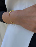 Female model wearing adjustable minimalist simple Success Thin Cuff Chunky Bold Layering Stacking Statement 2 Way convertible Bangle Cuff Open Bracelet in 18K Gold Vermeil with 925 sterling silver base by Sonia Hou, a celebrity AAPI Chinese demi-fine fashion costume jewelry designer