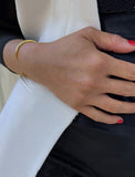 Female model wearing adjustable minimalist simple Success Thin Cuff Chunky Bold Layering Stacking Statement 2 Way convertible Bangle Cuff Open Bracelet in 18K Gold Vermeil with 925 sterling silver base by Sonia Hou, a celebrity AAPI Chinese demi-fine fashion costume jewelry designer