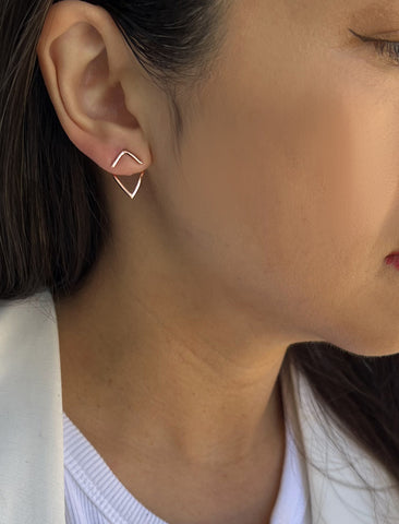 Image Title Female model wearing small modern geometric minimalist simple 2-way convertible TRILL dainty wishbone diamond front back ear jacket stud earrings in 18K rose gold vermeil with 925 sterling silver base by Sonia Hou, a celebrity AAPI Chinese demi-fine fashion costume jewelry designer
