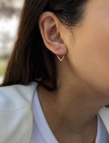 Female model wearing small modern geometric minimalist simple 2-way convertible TRILL dainty wishbone diamond front back ear jacket stud earrings in 18K rose gold vermeil with 925 sterling silver base by Sonia Hou, a celebrity AAPI Chinese demi-fine fashion costume jewelry designer