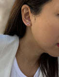 Female model wearing small modern geometric minimalist simple 2-way convertible TRILL dainty wishbone diamond front back ear jacket stud earrings in 18K rose gold vermeil with 925 sterling silver base by Sonia Hou, a celebrity AAPI Chinese demi-fine fashion costume jewelry designer