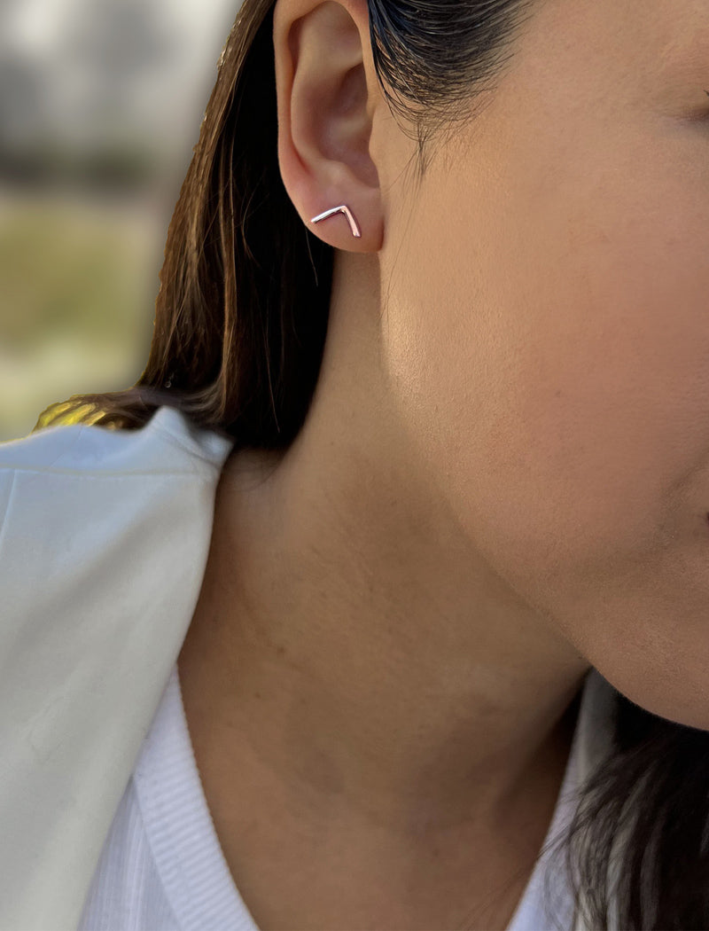 Image Title Female model wearing small modern geometric minimalist simple 2-way convertible TRILL dainty wishbone diamond front back ear jacket stud earrings in 18K rose gold vermeil with 925 sterling silver base by Sonia Hou, a celebrity AAPI Chinese demi-fine fashion costume jewelry designer