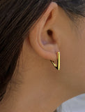 Female model wearing ACHIEVE TRIANGLE GEOMETRIC HUGGIE EARRINGS IN 18K GOLD VERMEIL With Sterling Silver base by Sonia Hou Jewelry