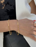 Female model wearing Asian Inspired Minimalist 2 Way Convertible Lucky Charm Coin Four Blessings Pendant With A Paperclip Link Chain Statement Bold Thick Chunky Layering Stacking Rectangular Bracelet in 18K Gold Vermeil With Sterling Silver base by Sonia Hou, a celebrity AAPI Chinese demi-fine jewelry designer