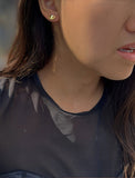 Image Title Female model wearing tiny dainty small minimalist inclusive Evil Eye Stud Earrings, inspired by Greek culture, in 18K Gold Vermeil With Sterling Silver base by Sonia Hou, a celebrity AAPI Chinese demi-fine fashion costume jewelry designer