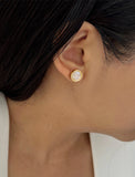 Image Title Female model wearing luxe minimalist small or big FIRE 3-Way Convertible White Quartz Gemstone Round Stud earrings in 24K Gold by Sonia Hou, a celebrity AAPI Asian Chinese demi-fine fashion costume jewelry designer.
