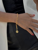 Female model wearing Asian Inspired Minimalist 2 Way Convertible Lucky Charm Coin Four Blessings Pendant With A Large Paperclip Link Chain Statement Bold Thick Chunky Layering Stacking Rectangular Bracelet in 18K Gold Vermeil With Sterling Silver base by Sonia Hou, a celebrity AAPI Chinese demi-fine jewelry designer